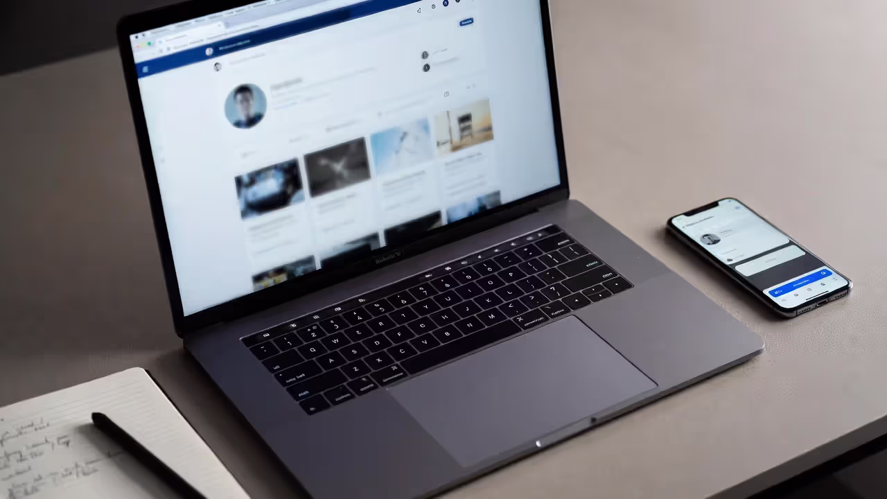 Laptop and smartphone showing blurred networking tools on a desk