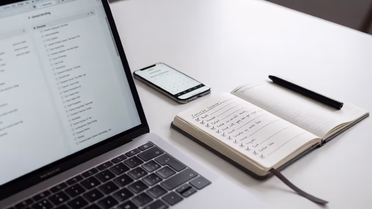 Event research setup with laptop, calendar, and notes for founder networking