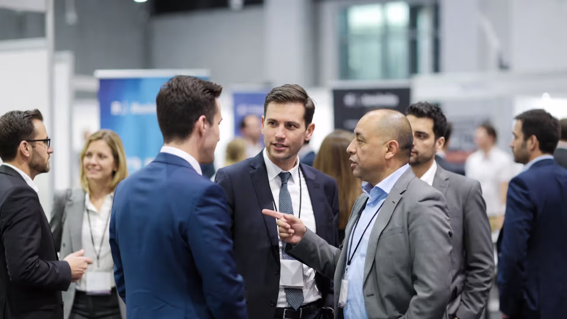 Professionals networking in small groups at a business conference.