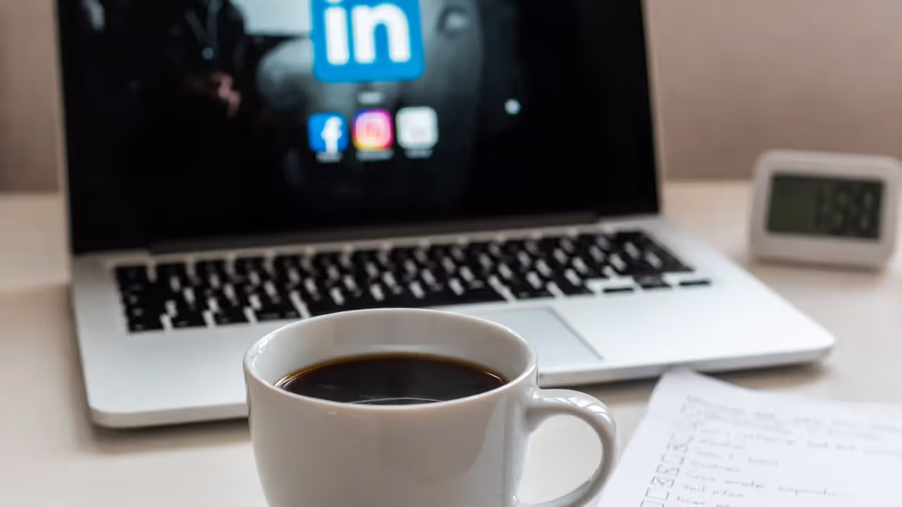 Morning routine for networking with laptop, coffee, and a checklist on desk