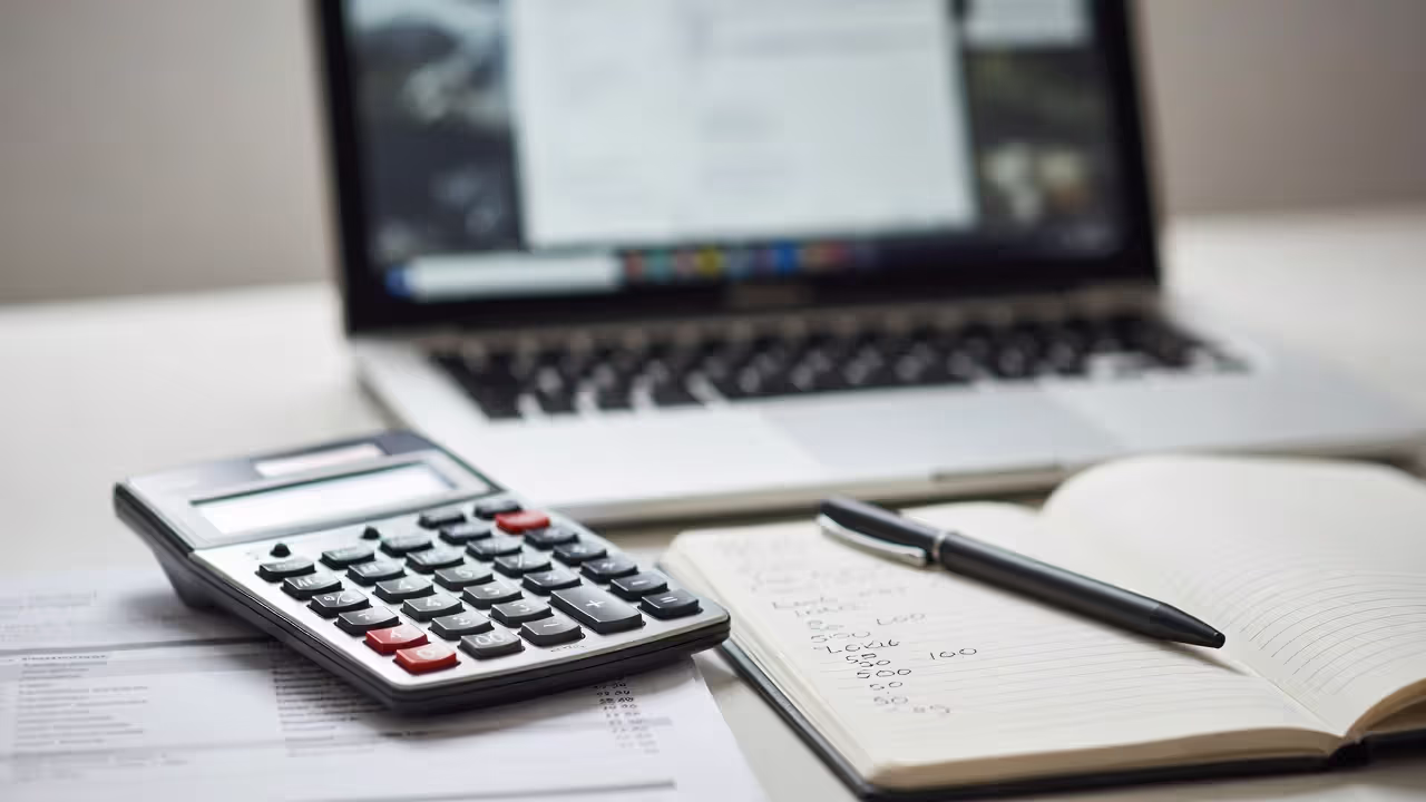 Event cost calculations and event plan on an office desk