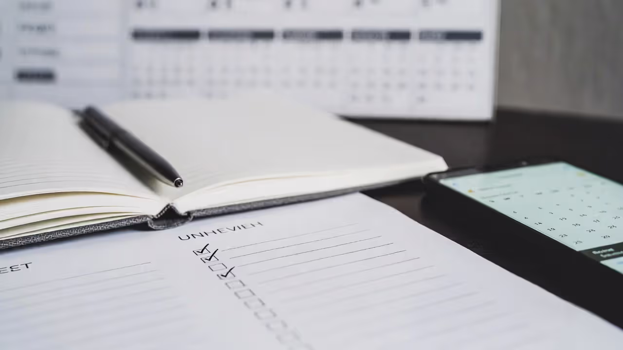 Tracking small networking goals with a checklist and reminders on a desk