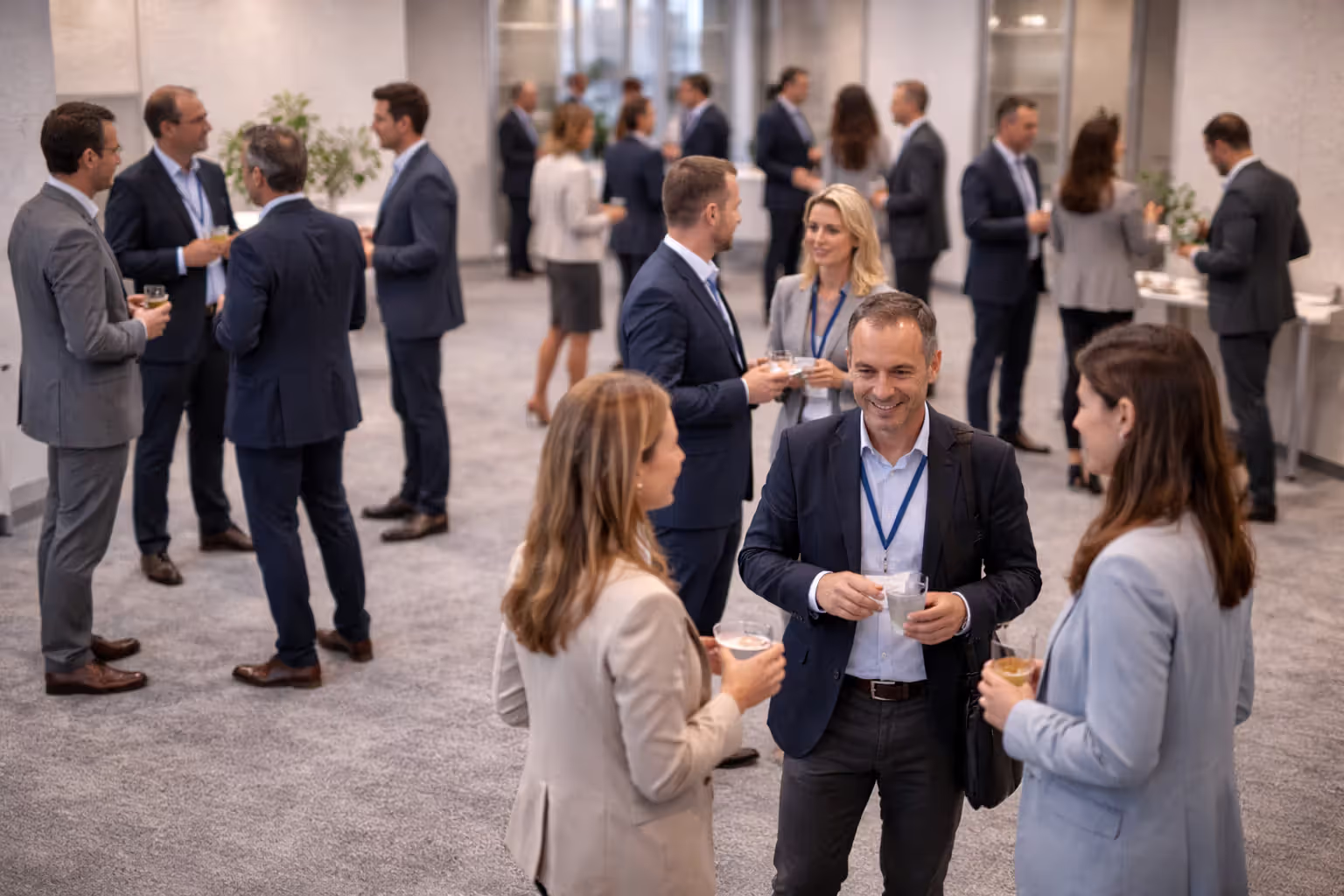 Small clusters of professionals forming conversation groups in a conference room