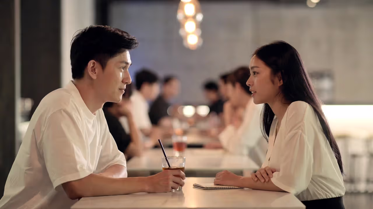 Two people having an engaged conversation at a happy hour without visible name tags